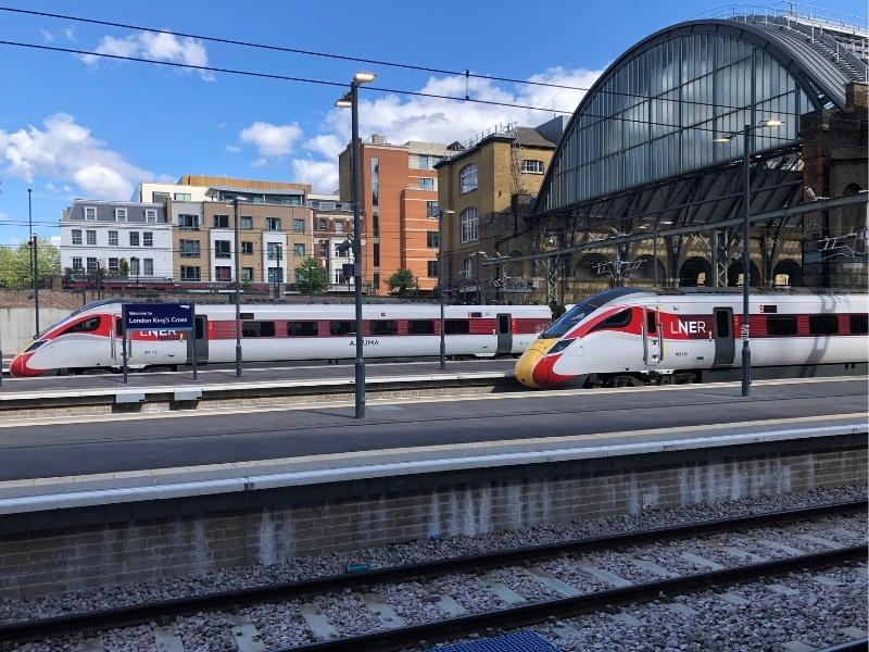 Two trains at a train station in the UK.