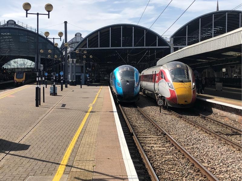 Two trains at a UK train station.