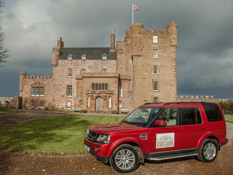 Red Land Rover in front of the Castle of May.