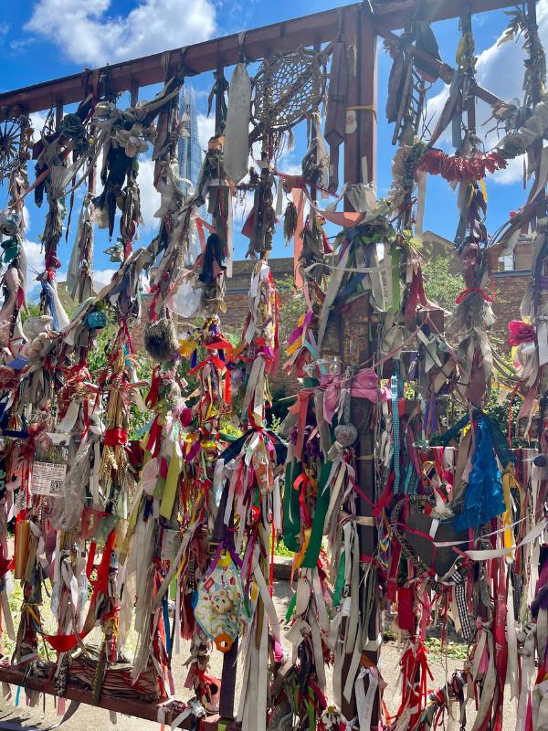 Ribbons tied on a gate at Cross Bones Burial ground London.