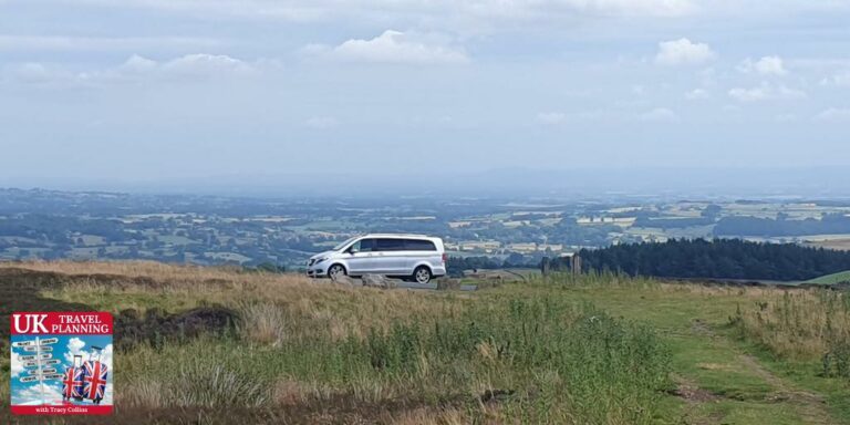 Car with countryside in the background.