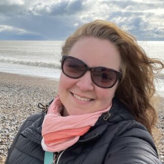 a woman taking a selfie on a beach