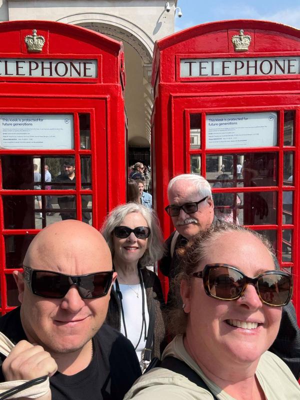 Kristens husband and Mum and Dad at a red phone