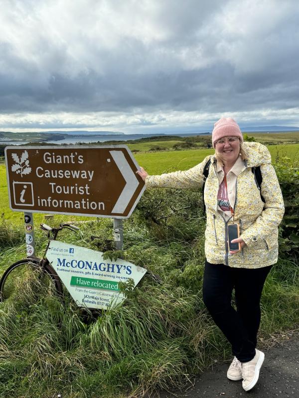 Tracy with sign for Giants Causeway