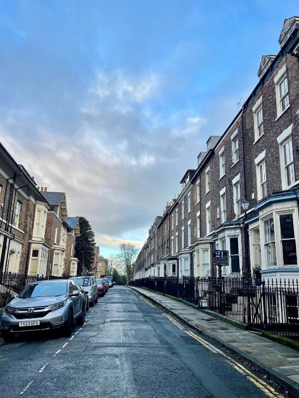 Road with cars parked.
