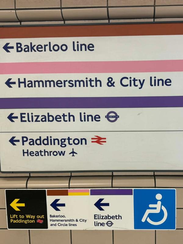 Accessible travel UK — London Underground directional sign showing accessible lift route to the Elizabeth line, Paddington and Heathrow