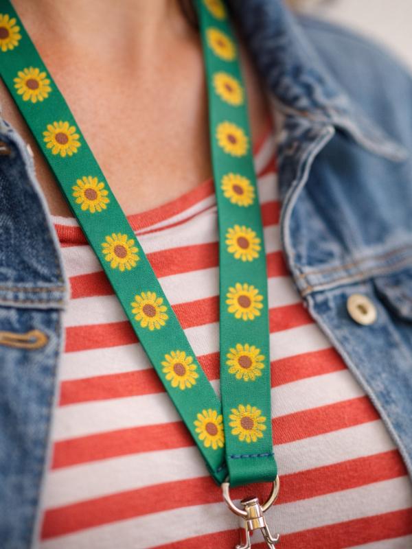 Accessible travel UK — Hidden Disabilities Sunflower lanyard being worn, a discreet way to indicate non-visible disabilities at UK airports, stations and attractions