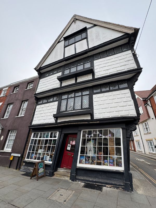 A crooked historic timber-framed building in Canterbury on an English Bus day tour from London