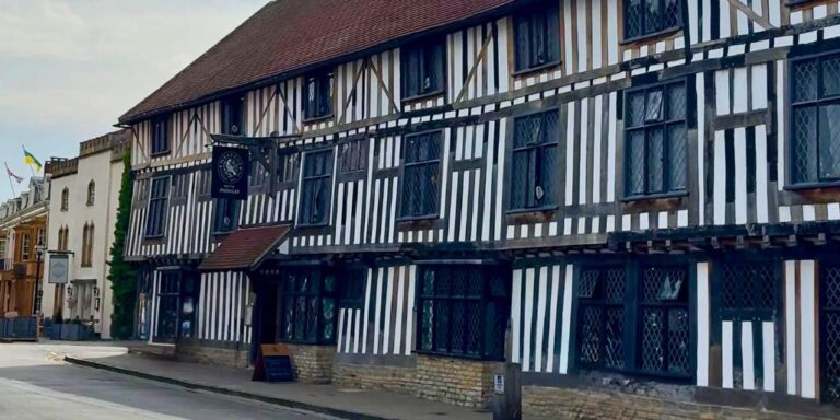 Exterior of Hotel Indigo Stratford-upon-Avon, a historic black and white timber-framed building with leaded windows