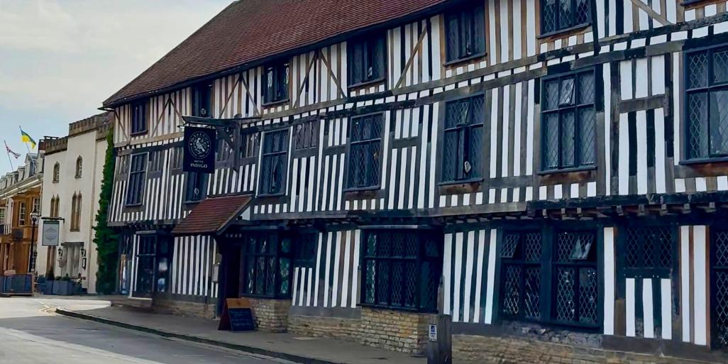 Exterior of Hotel Indigo Stratford-upon-Avon, a historic black and white timber-framed building with leaded windows