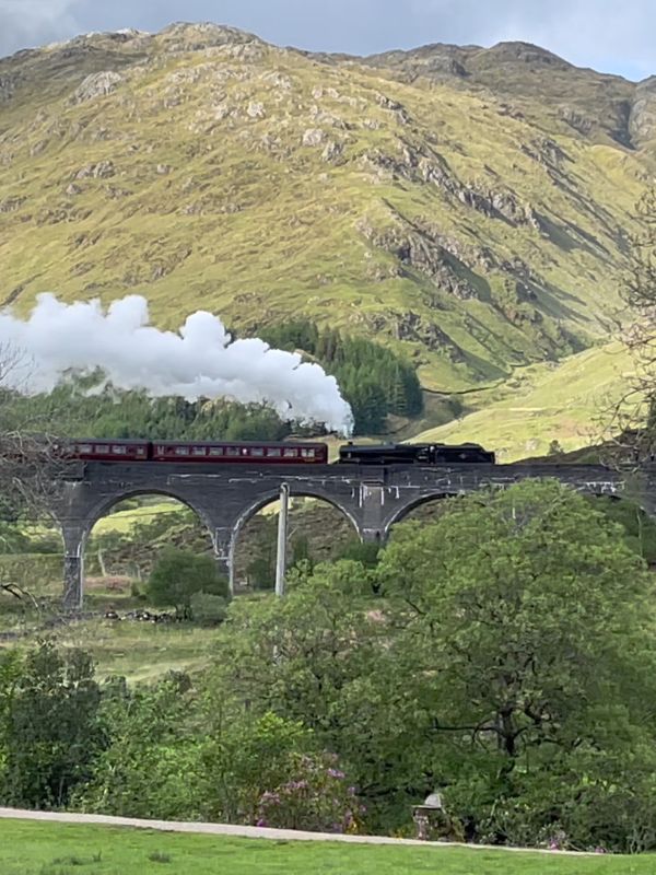 The 21-arch Glenfinnan Viaduct curving above Loch Shiel on the West Highland Line