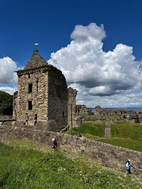 The ruins of St Andrews Castle on a sunny day, with the sea visible beyond the castle walls