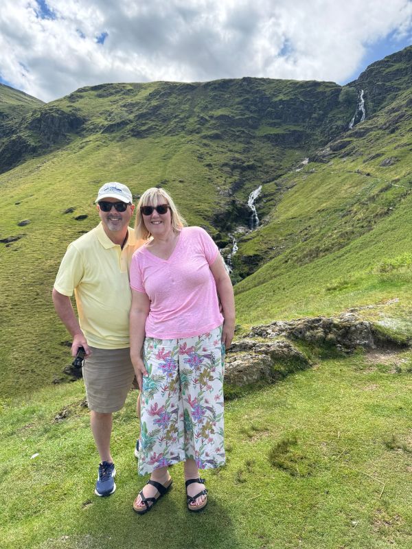 Tracy and Doug Collins at the top of a mountain pass in the Lake District