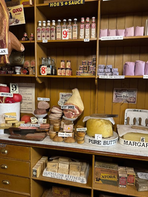 Hams, cheeses, pork pies and a block of pure butter on the marble counter of the Co-op grocery at Beamish Museum